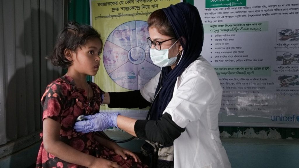 Doctor from Nawadipa Medical Care examining a young patient with care and professionalism.